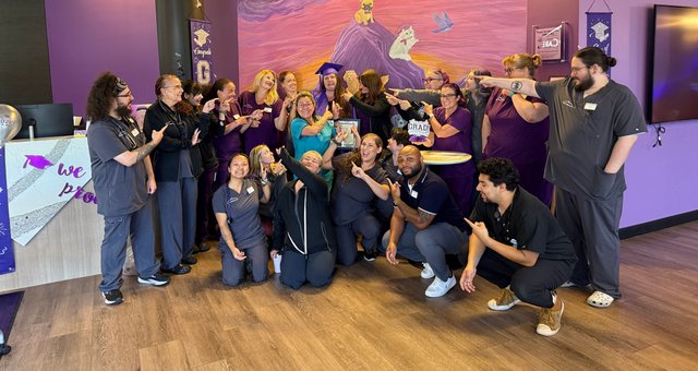 Christina celebrating her graduation with the Summit Veterinary Care team