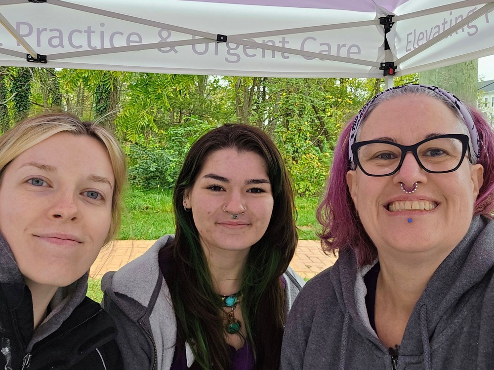 Summit Veterinary Care team members smiling under the SVC tent at Haymarket Day 2026