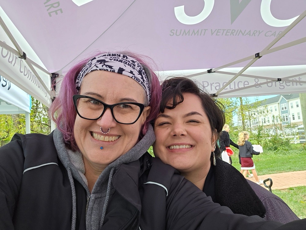 Two Summit Veterinary Care team members under the SVC tent at Haymarket Day 2026