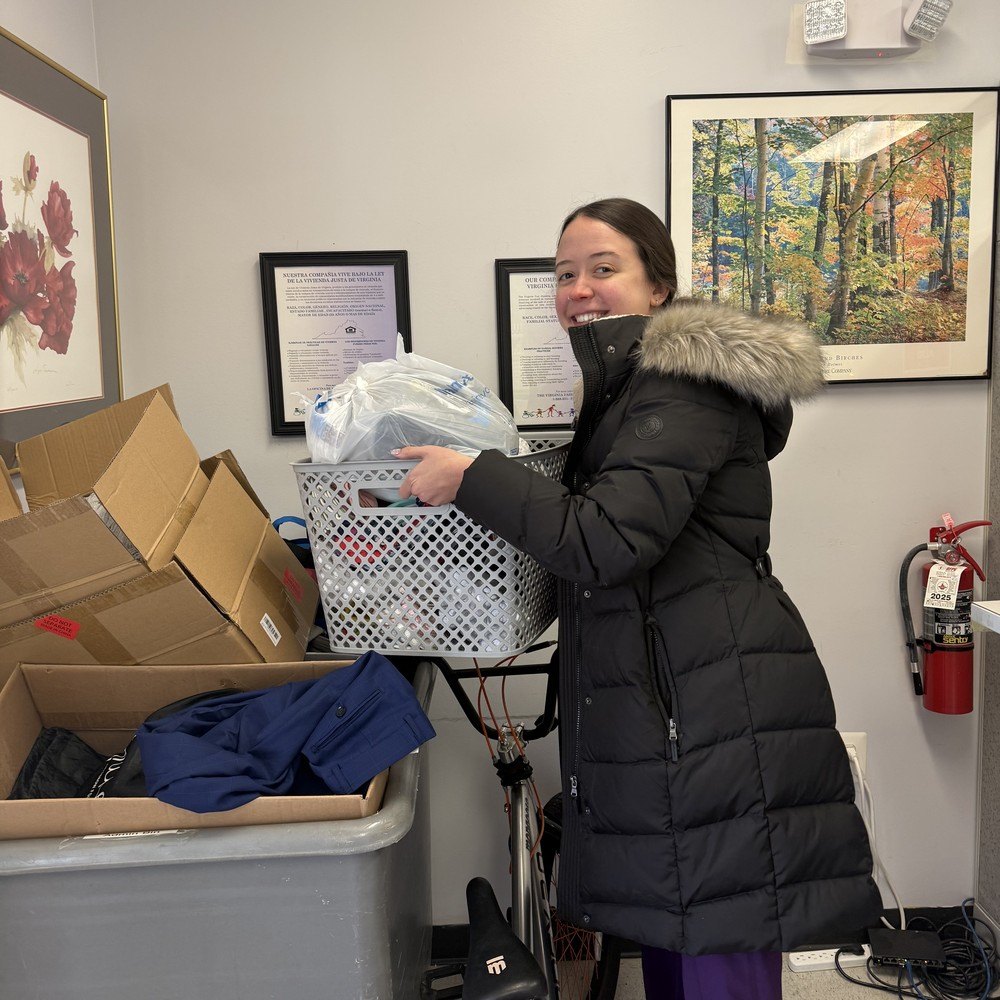 A Summit Veterinary Care team member delivering donated socks to SERVE Family Shelter